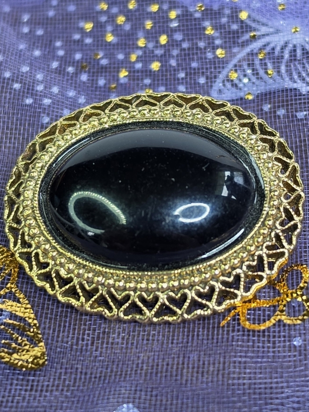 1928 Gold-Tone Brooch with Black Oval Cabochon
